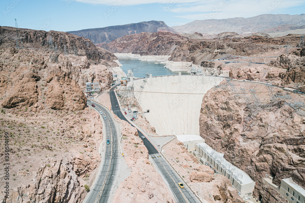 overview of freeway running alongside hoover dam. panoramic view of rugged landscape around lake mea