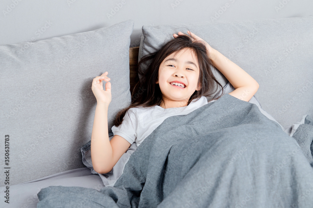 Asian little girl sleeping in bed