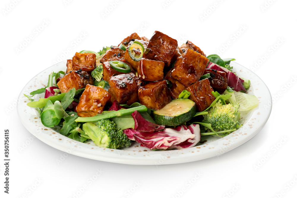 Plate with tasty tofu cheese and vegetables on white background