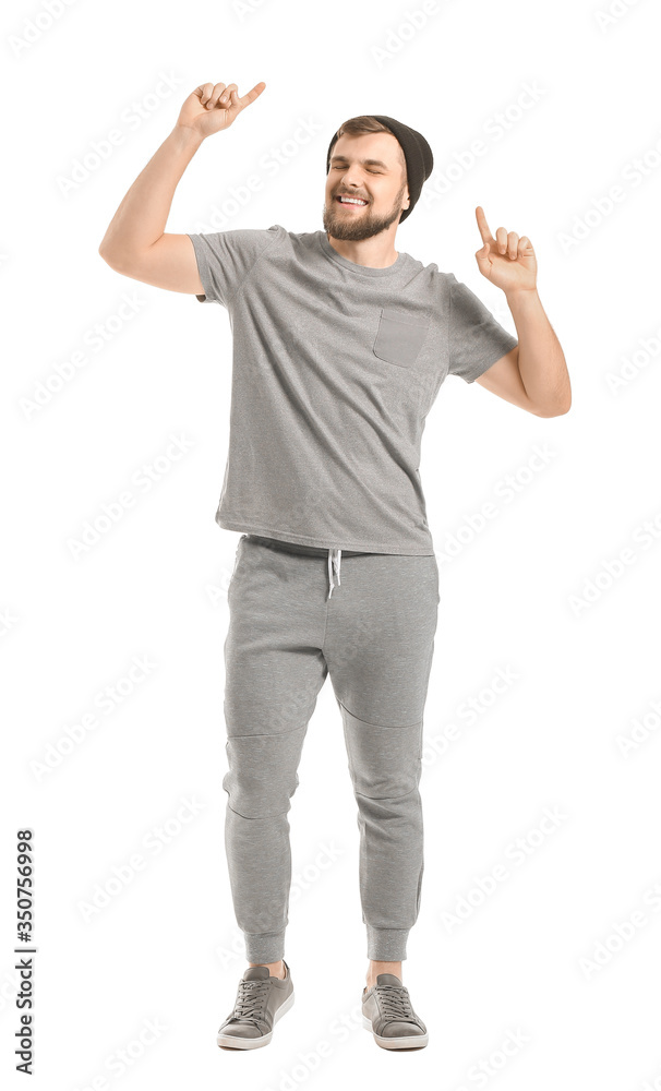 Handsome young man dancing against white background