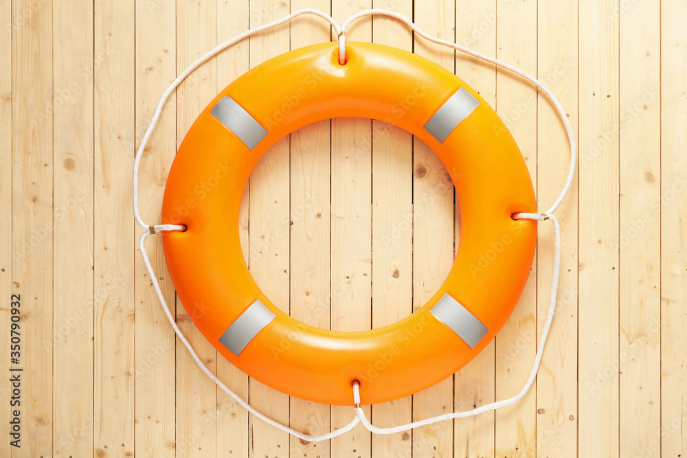 Lifebuoy ring on wooden background