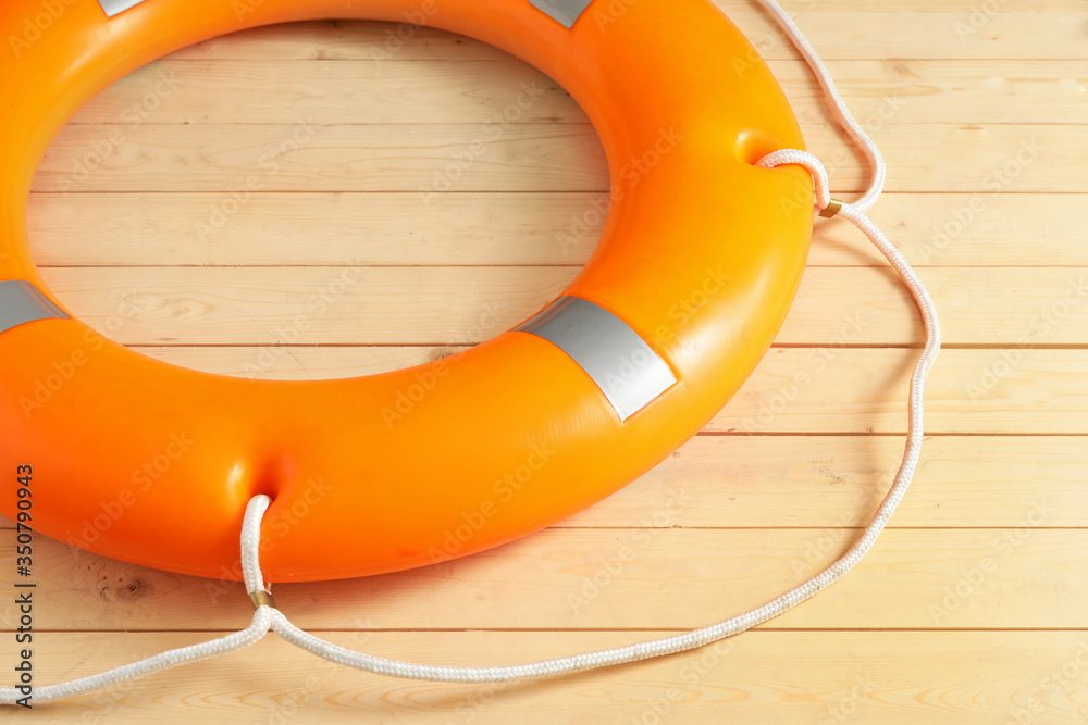 Lifebuoy ring on wooden background