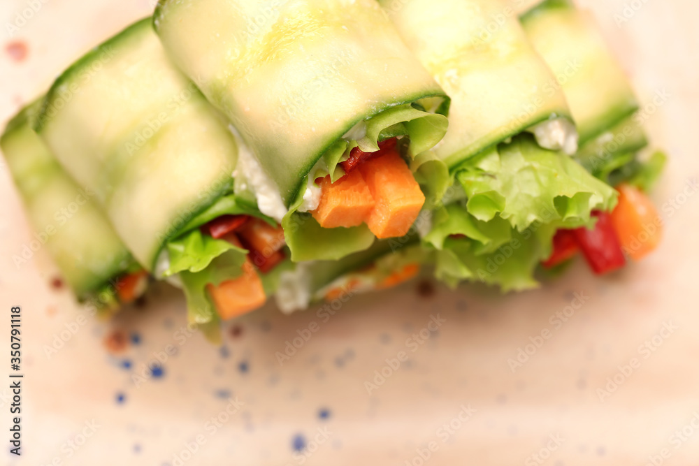 Plate with tasty cucumber rolls, closeup