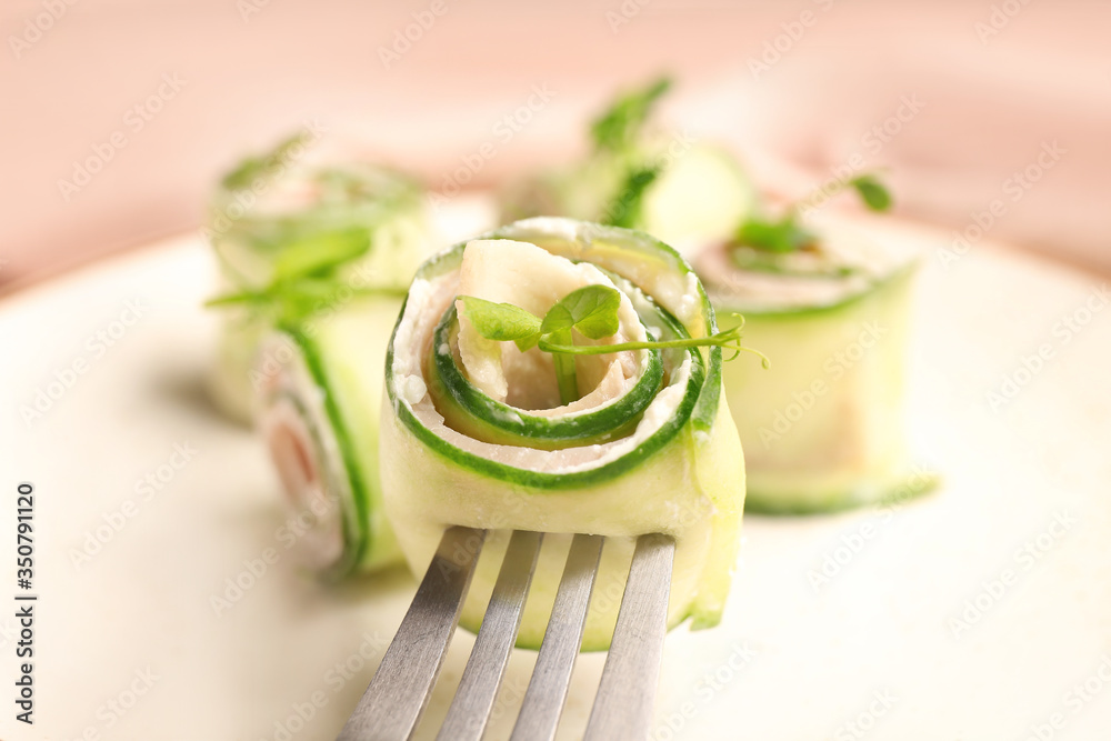 Plate with tasty cucumber rolls, closeup