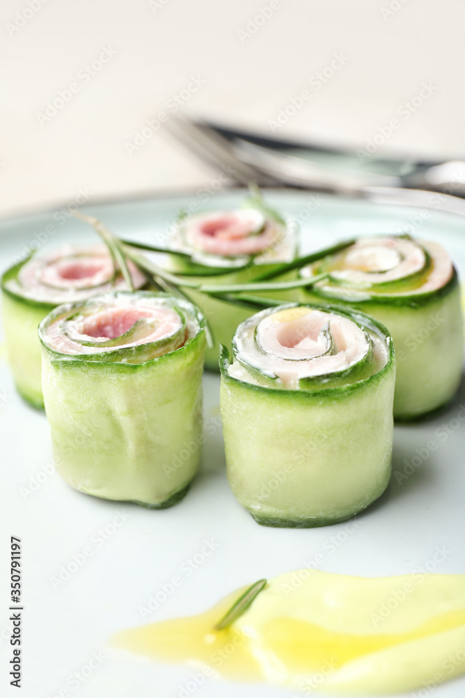 Plate with tasty cucumber rolls, closeup