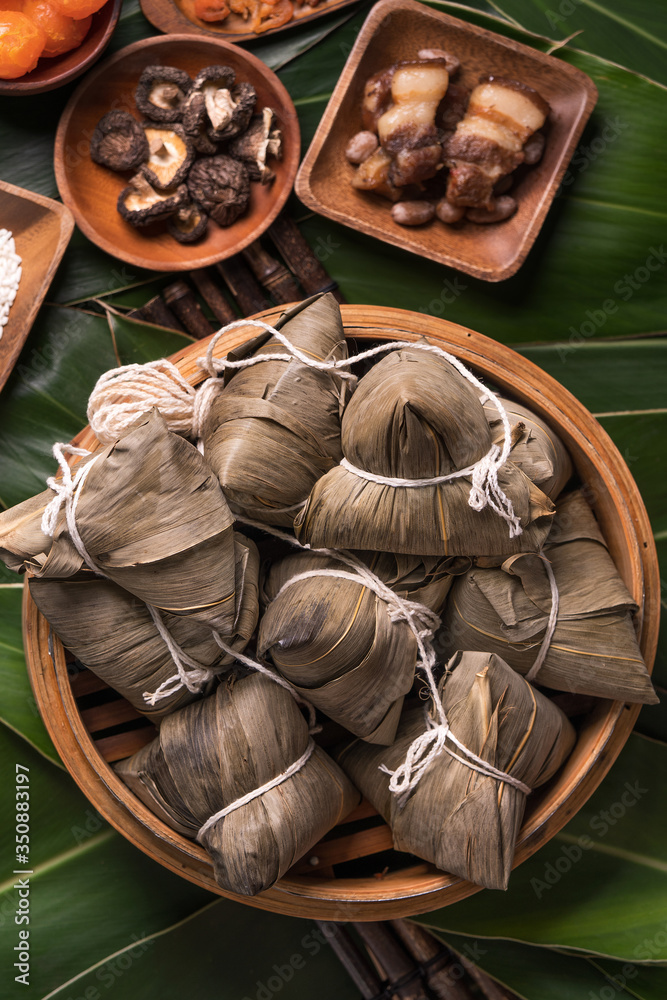 Rice dumpling, zongzi - Traditional Chinese food on green leaf background of Dragon Boat Festival, D