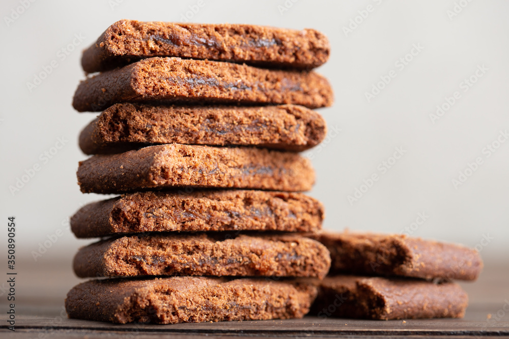 Chocolate home made cookies on the wooden table. Stacked chocolate chip cookies close up