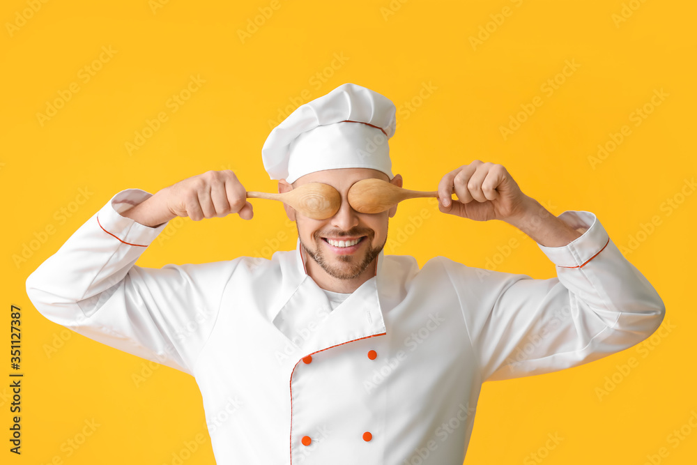 Portrait of male chef on color background