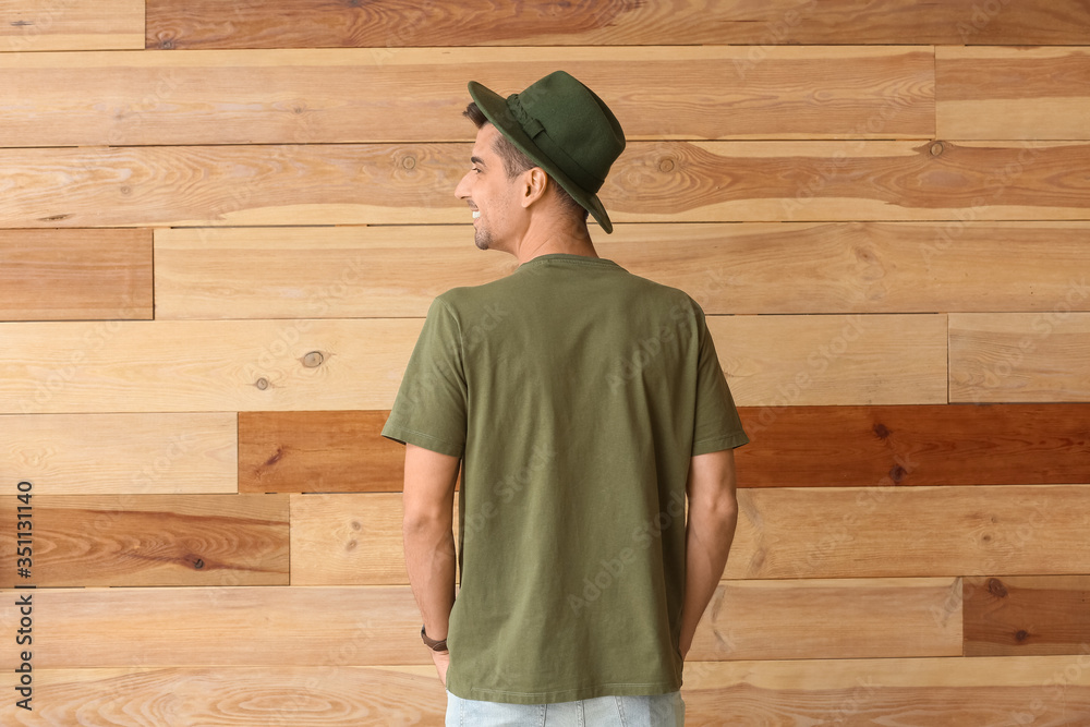 Man in stylish t-shirt on wooden background