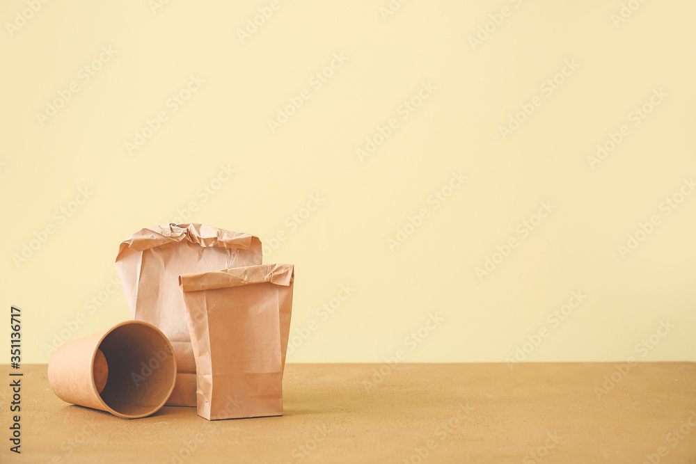 Paper bags and cup on table