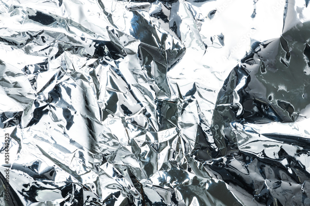 Crumpled aluminum foil textured background