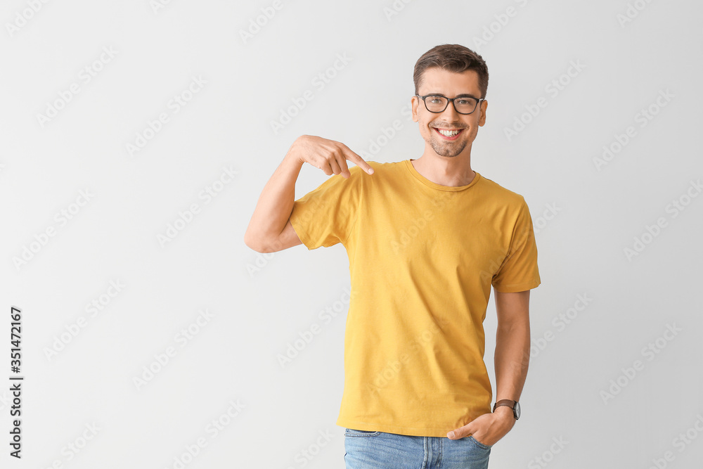 Man in stylish t-shirt on grey background