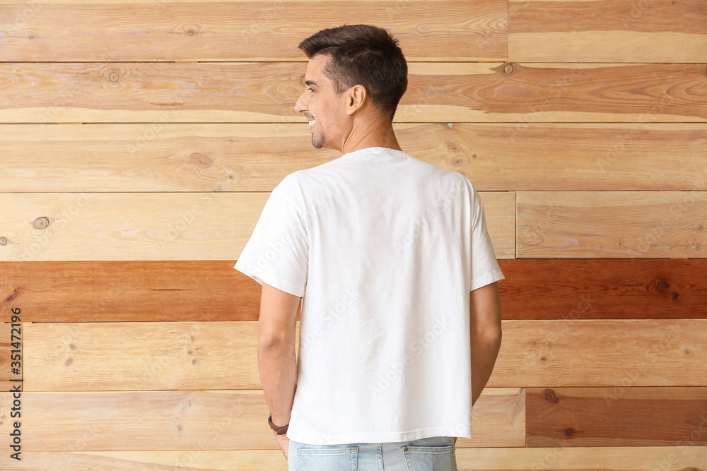 Man in stylish t-shirt on wooden background