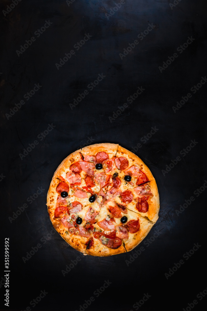 Traditional Italian pizza on a dark metallic background. Pizza cooking in the oven. Pizza menu. Top 