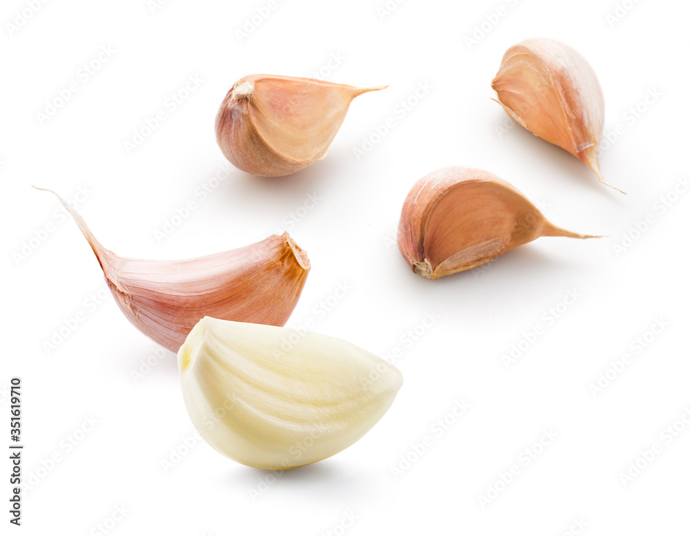 Garlic white background. Garlic cloves on white. Garlic clove isolated. Peeled, unpeeled garlic clov