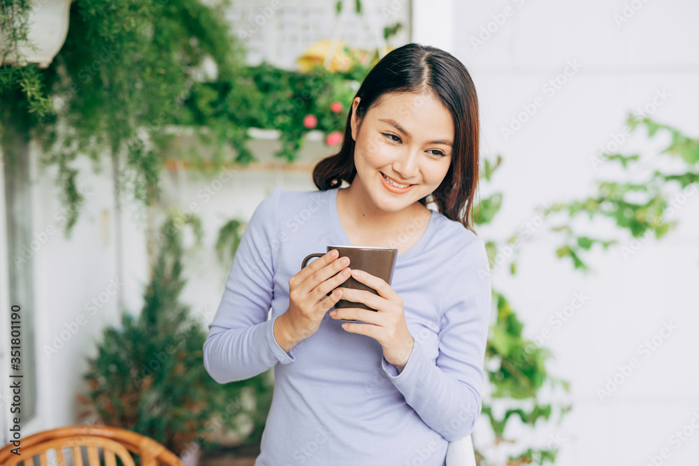 Woman enjoy her coffee at the balcony