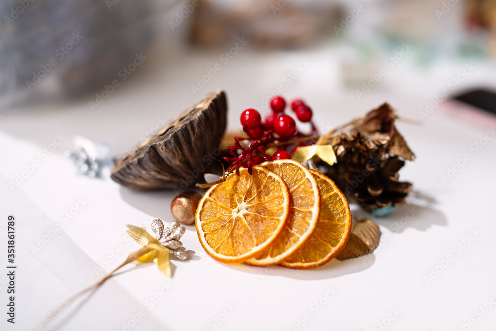 on a white background are details, dried oranges, twigs and berries for decoration,