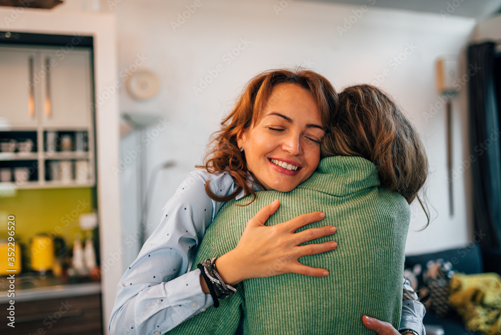 Family reunion. Mother and daughter embracing at home, portrait, close-up.