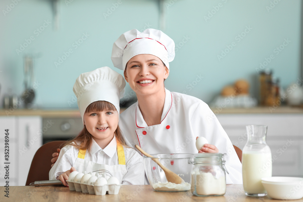 女厨师和她的小女儿在厨房做饭