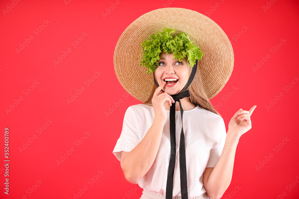 Young woman with lettuce on color background. Diet concept