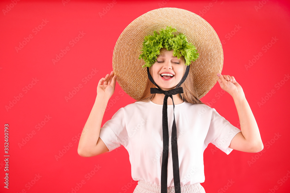 Young woman with lettuce on color background. Diet concept