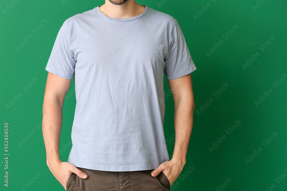 Man in stylish t-shirt on color background