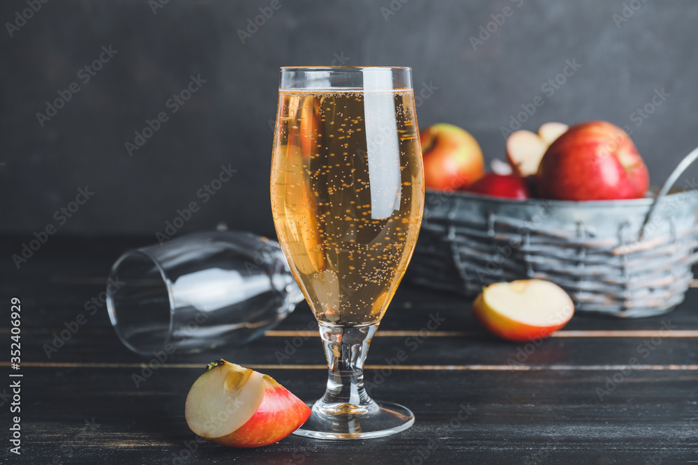 Glass of apple cider on dark background