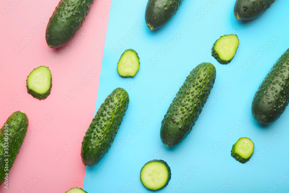 Fresh green cucumbers on color background