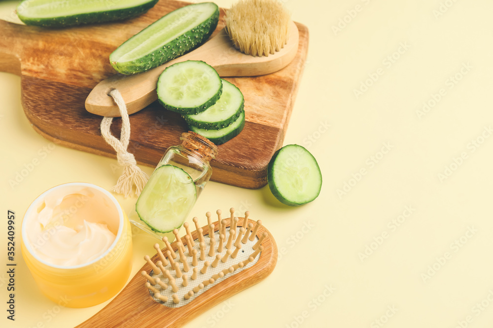 Composition with cucumber and cosmetics on color background