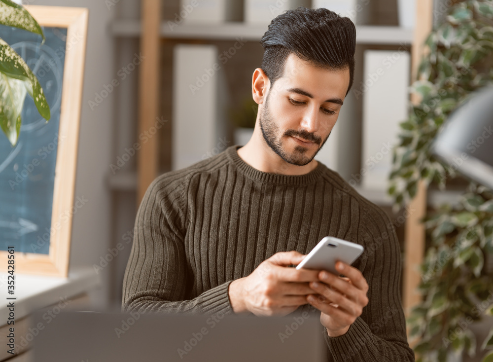 man working on a laptop at home.