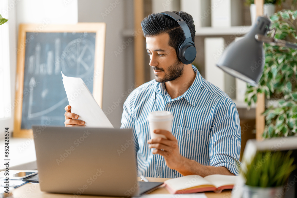 man working on a laptop at home.