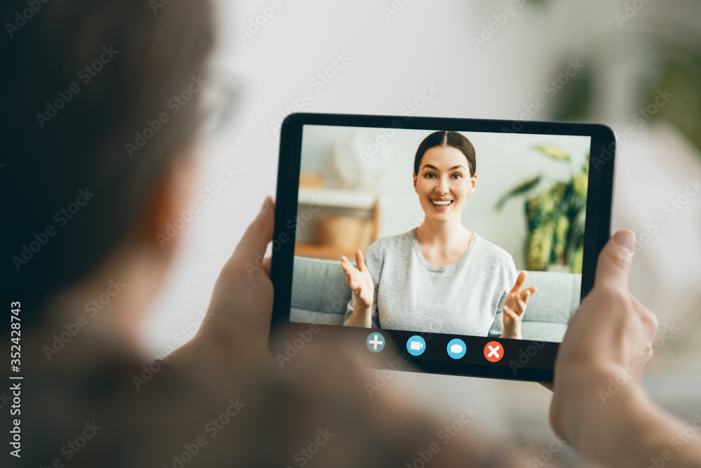 man is using tablet pc for remote conversation