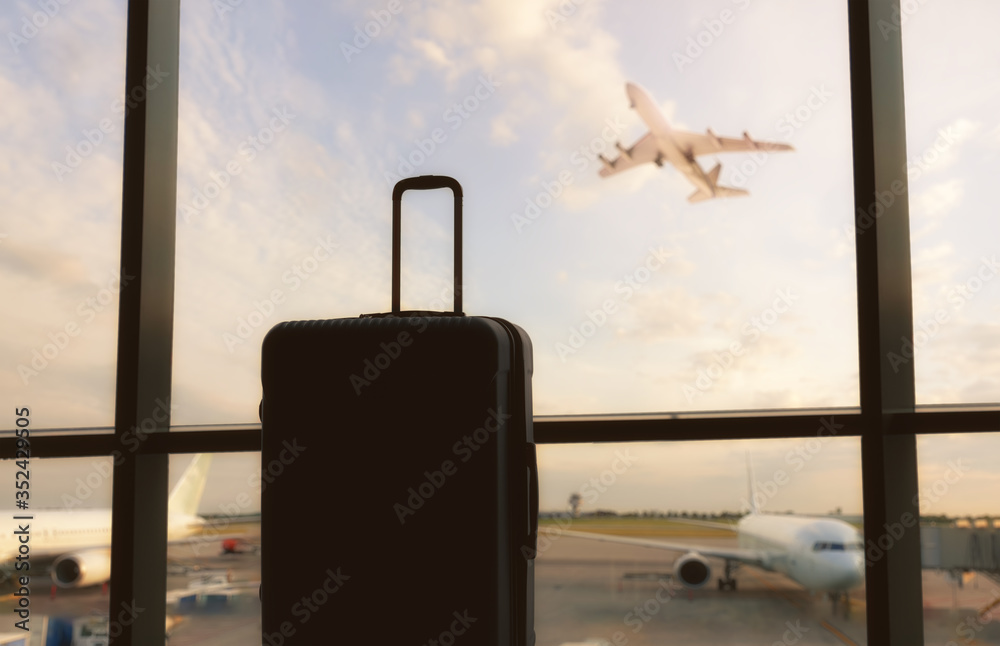 Suitcase near window at the airport.