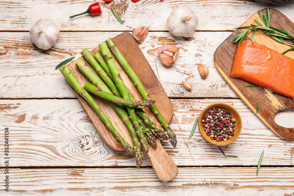 Asparagus with salmon, vegetables and spices on table