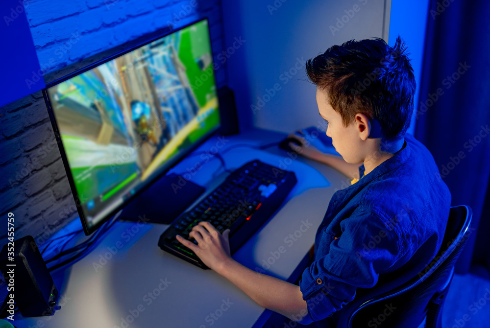 Teenage boy playes videogames. Addicted to video gaming at home