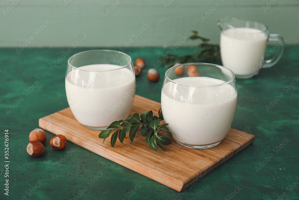 Glasses of tasty hazelnut milk on table