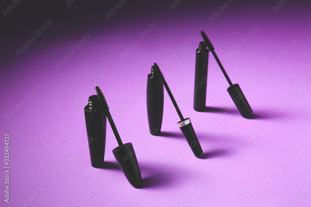 Black mascara on color background