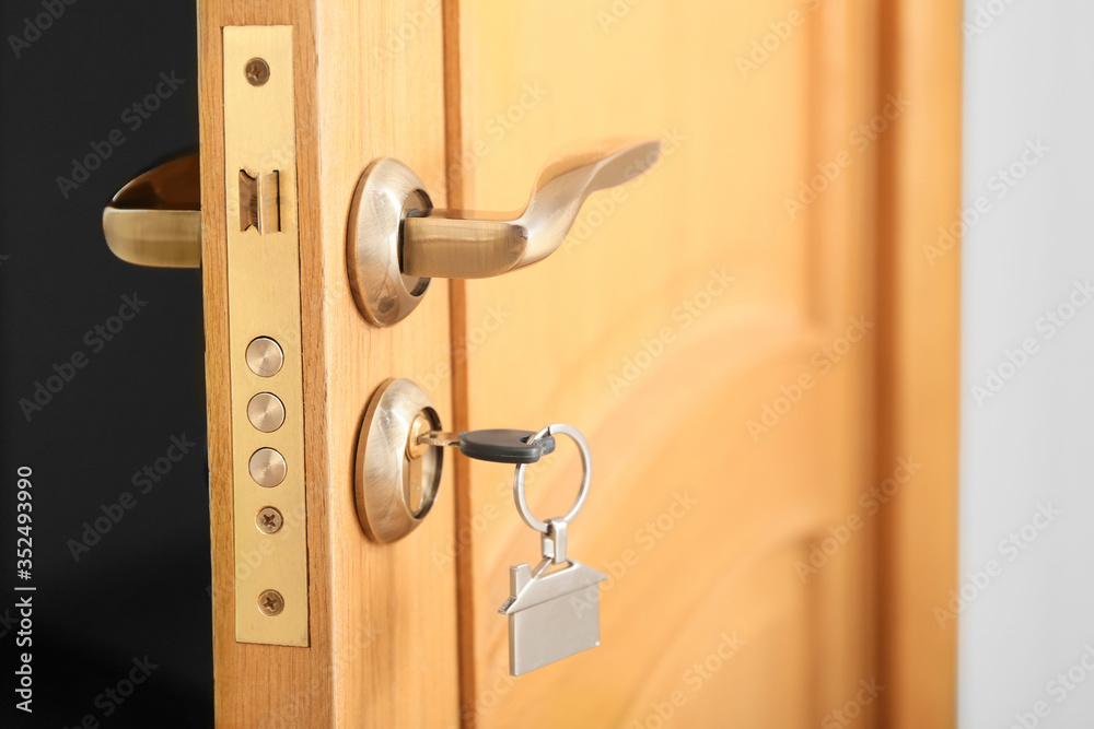 View of modern door with key, closeup