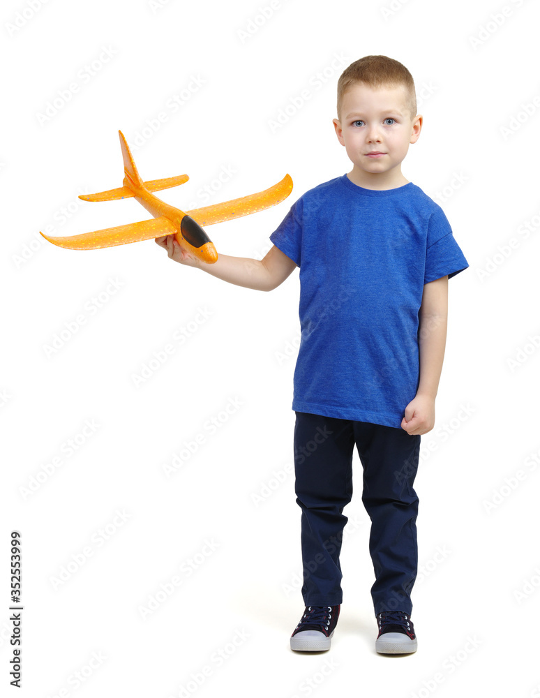 Little boy playing with a toy airplane.