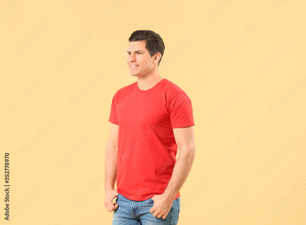 Man in stylish t-shirt on color background