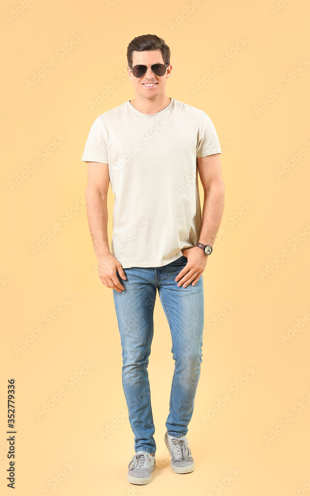 Man in stylish t-shirt on color background