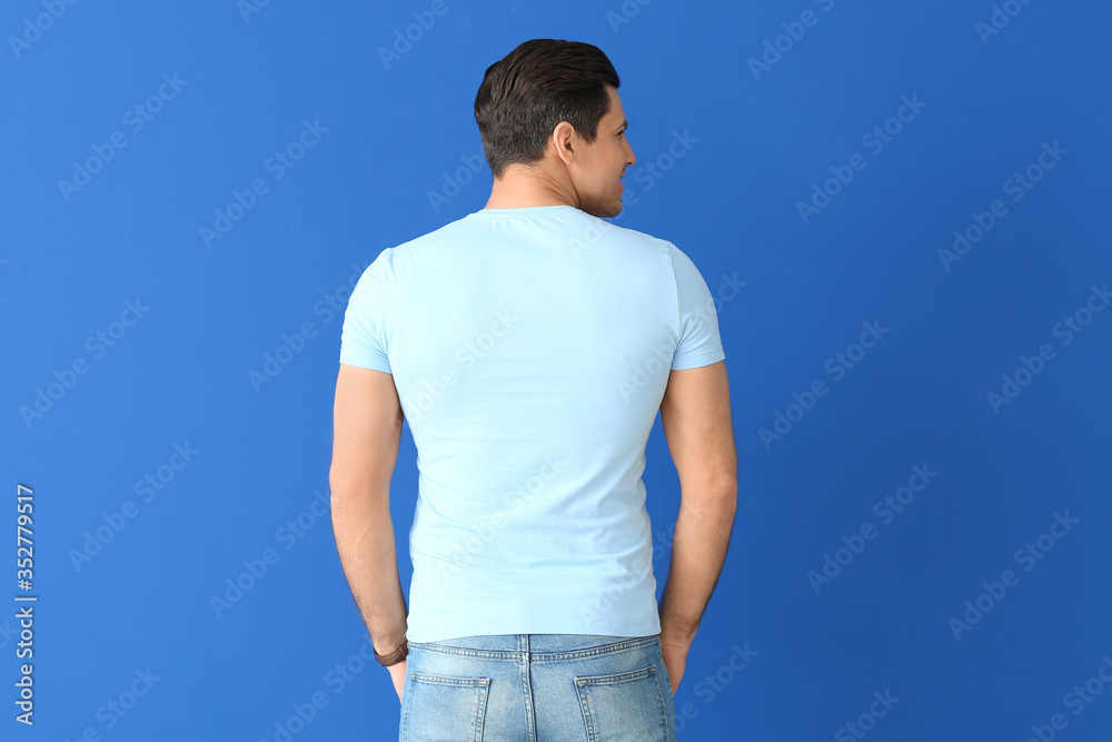 Man in stylish t-shirt on color background