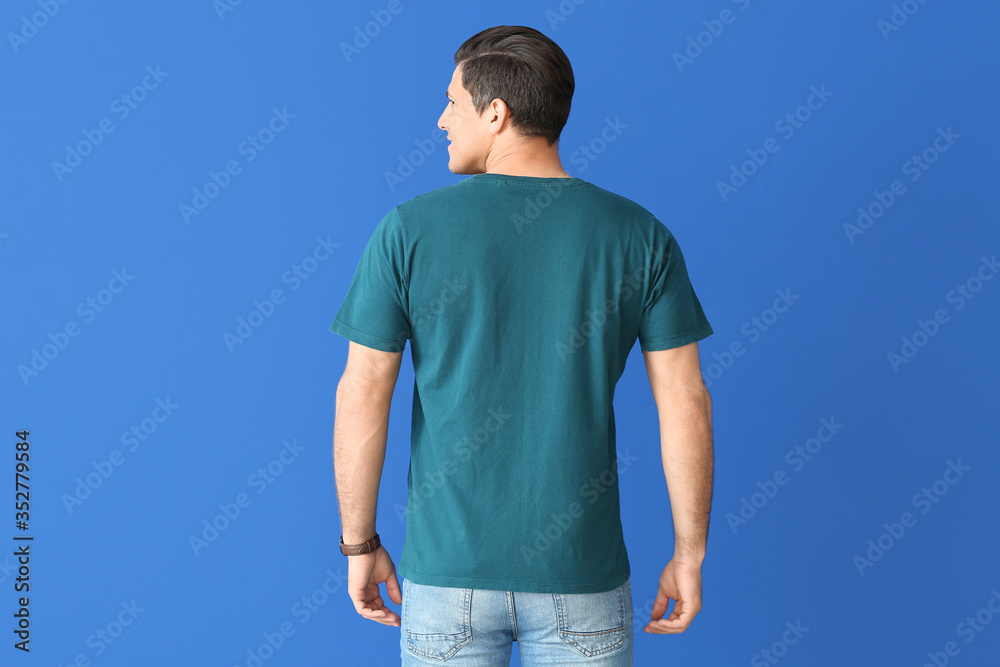 Man in stylish t-shirt on color background