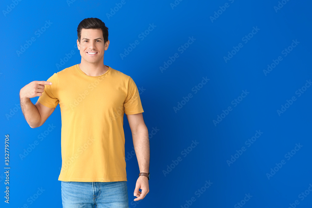 Man in stylish t-shirt on color background