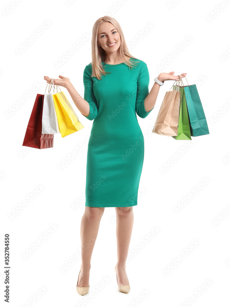 Beautiful young woman with shopping bags on white background