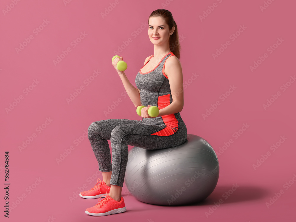 Sporty young woman training on color background