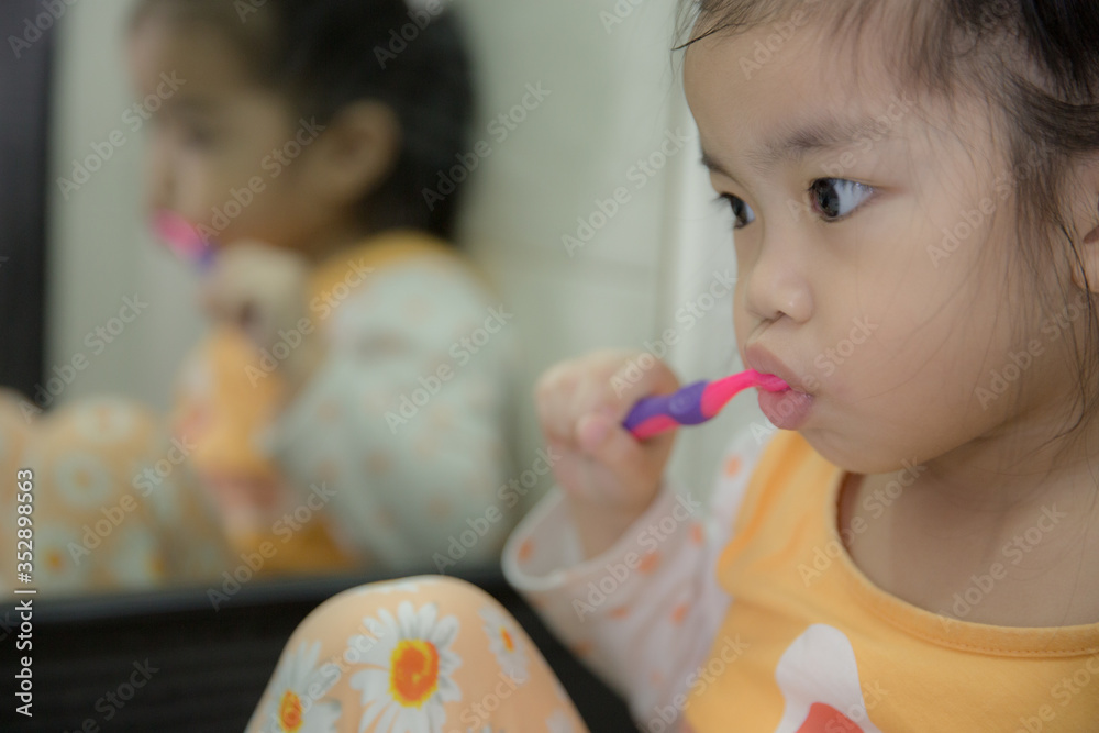 Little asian cute girl brush teeth