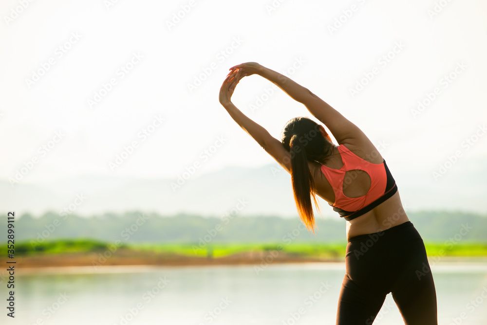 Back side of relax asian woman standing  doing yoga with nature background