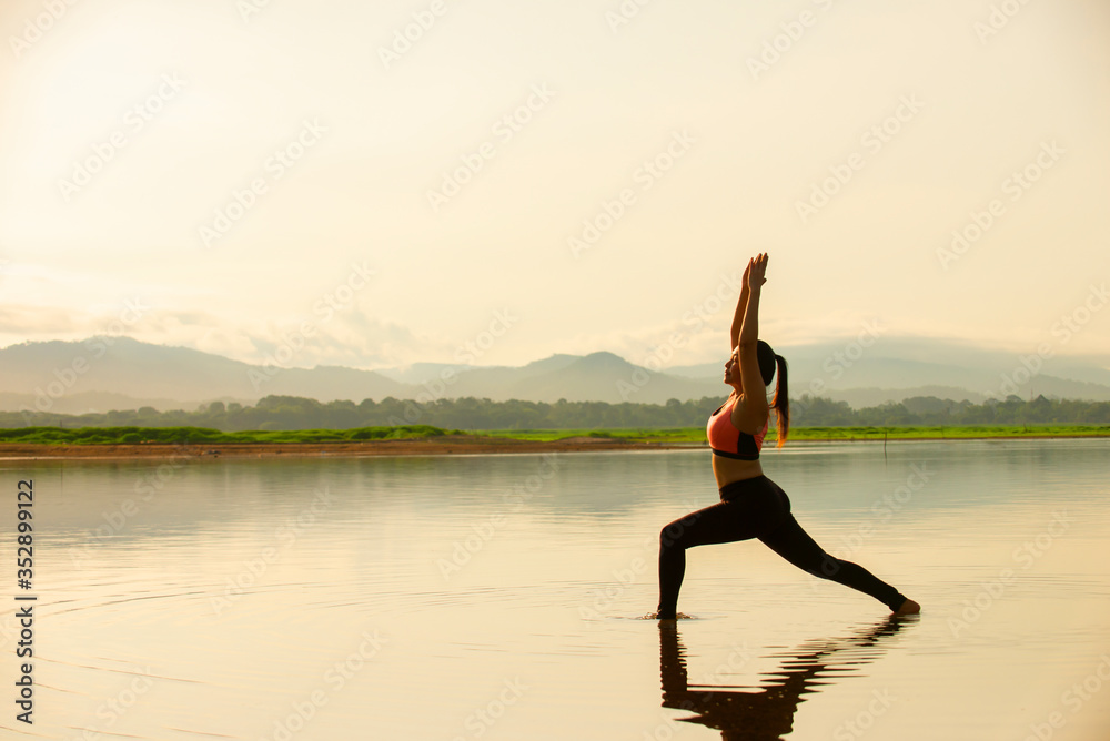 Relax asian woman standing  doing yoga with nature background