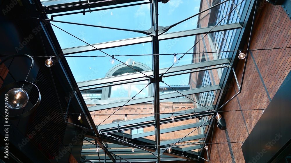 Glass ceiling with lamps in revitalized building.